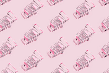 Pattern of supermarket shopping cart on pastel pink background. Creative design for packaging. Online shopping. Seamless pattern. Black friday sale concept.  Sustainable, minimalist lifestyle.