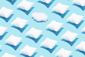 Pattern made of white pillows and one cotton cloud on serenity pastel blue background. Sleeping concept. Isometric flat lay. Break the pattern.
