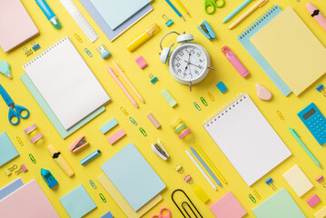 Back to school concept. Top view photo of alarm clock diaries correction pens binder clips stapler...