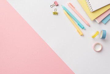 Back to school concept. Top view photo of stationery stack of colorful notepads pens binder clips...