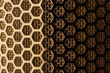 A closeup of the mesh of a gold plated ribbon microphone