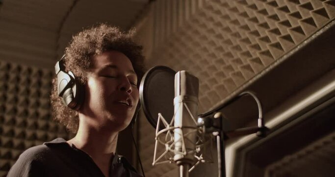 Black woman rapping in recording studio