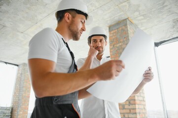 View of a Worker and architect watching some details on a construction