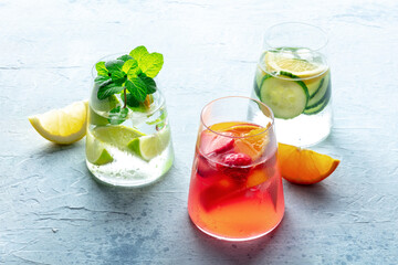 Summer cocktails. Cold drinks with fresh fruits. Healthy mocktails. Citrus, strawberry and cucumber lemonades