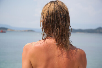 Woman's hair on the beach. Wet hair close up image. Hair damage due to salty ocean water and sun, summertime hair care concept. - obrazy, fototapety, plakaty
