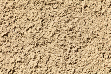 Decorative plaster on the wall of the house as an abstract background.
