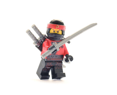 Editorial illustrative image of lego ninjago minifugure Kai red ninja with sword weapon on white background