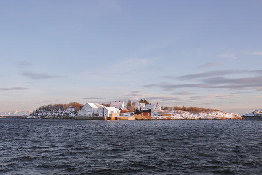Little artic island with some houses. Cold landscape of northern Norway, the rorbuers arre covered with snow at winter