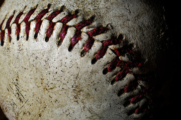 Atmospheric photo of an old baseball. Detailed closeup showing marks from a lot of use in extreme detail
