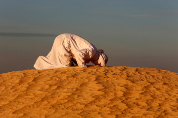 Beduin praying in the Sahara
