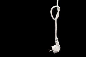 Electric plug for a socket with a knot on a cable on a black background with free space for text. The concept of the inability to get energy or electricity. No access to electricity or power outages - obrazy, fototapety, plakaty