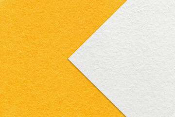 Texture of bright yellow paper background, half two colors with white arrow. Structure of craft orange cardboard.