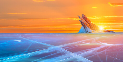 Ogoy island on winter Baikal lake with transparent cracked blue ice at sunrise - Baikal, Siberia,...