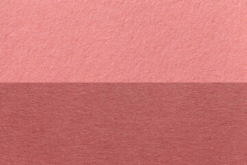 Texture of craft pink and maroon paper background, half two colors, macro. Structure of vintage dense rose cardboard.