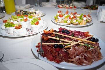 The banquet table. Tableware. Food, snacks, fruits, drinks