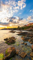 gorgeous sunrise at the sea. rocky seashore and clouds in morning light. stunning view. summer vacations and weather change concept