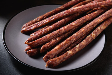 Smoked Sausages with Lard, Meat Lies on Gray Plate. Snack for Beer Close-up.
