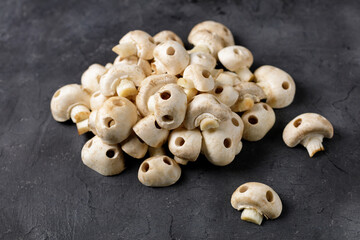 A bunch of raw champignon mushrooms in the form of skulls. Edible Halloween Concept