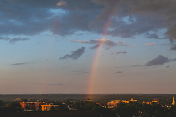 Cloudy sky and sunset in summer day, rainbow in Hackensack New Jersey. Area view. High-quality photo