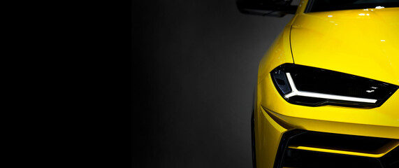 Yellow super car headlights on black background, copy space	