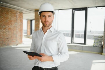 Close up engineers working on a building site holding a blueprints.Engineering and architecture concept