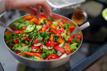 Selective focus of fresh chopped spring salad, man salt salad, backyard compilation of healthy food low calories food. High-quality photo