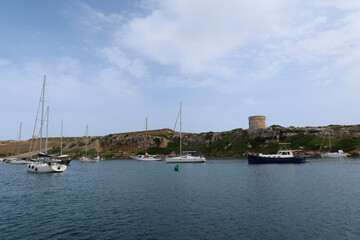 Fototapeta na wymiar Mahon (Mao), Minorca (Menorca), Spain. Port of Mahon - the largest natural port in the Mediterranean Sea. Small islands, fortifications, villas, boats make beautiful scenery. View from the cruise boat