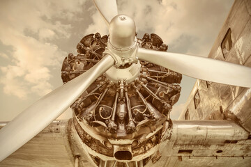 Retro styled image of a 1934 ancient passenger airplane engine with propeller