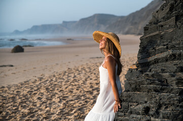 Woman standing near rock on beach