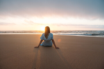 Unrecognizable woman admiring sea at sunset time