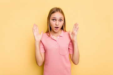 Young caucasian girl isolated on yellow background surprised and shocked.