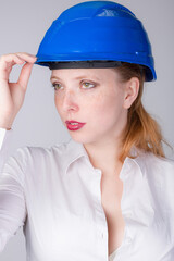 Young female engineer wearing a blue hard hat