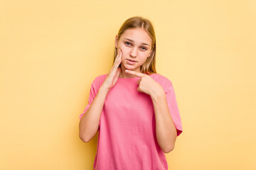 Young caucasian girl isolated on yellow background having a strong teeth pain, molar ache.