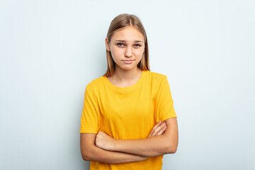 Fototapeta premium Young caucasian girl isolated on blue background unhappy looking in camera with sarcastic expression.