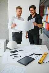 Engineers are helping to design work on blueprints and collaborate on structural analyzing of...