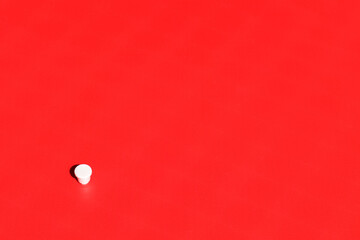 White cup on red background.