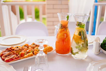 table served. jugs with lemonade and dried meat and tartlets