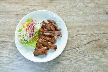 grilled slice pork steak dressing barbecue and salad on plate   