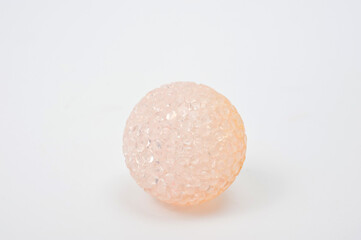 Beige pearlescent plastic ball for playing with pets.