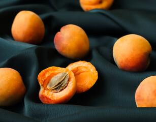 ripe fresh apricots on a green background