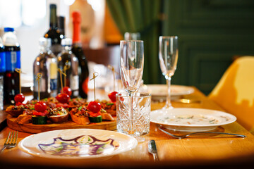 glasses, plates and sandwiches on the festive table. 