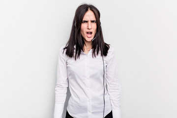 Telemarketer caucasian woman working with a headset isolated on white background screaming very angry and aggressive.