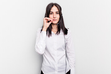 Telemarketer caucasian woman working with a headset isolated on white background with fingers on lips keeping a secret.