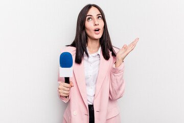 Fototapeta premium Young TV presenter caucasian woman isolated on white background surprised and shocked.