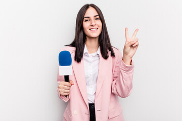 Fototapeta premium Young TV presenter caucasian woman isolated on white background showing number two with fingers.