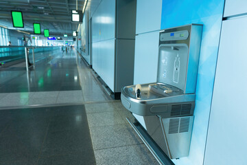 Sensor activated bottle filling station at airport