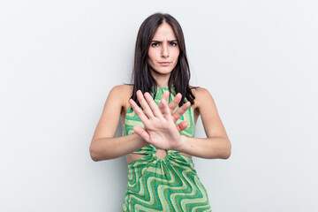 Young caucasian woman isolated on white background standing with outstretched hand showing stop...