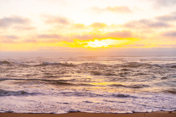 Landscape with sea sunset on beach. Beautiful view on ocean horizon with orange sun and clouds