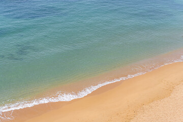 Fototapeta na wymiar Aerial view of sea waves and sandy beach