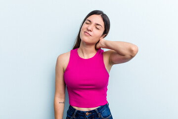 Young caucasian woman isolated on blue background massaging elbow, suffering after a bad movement.
